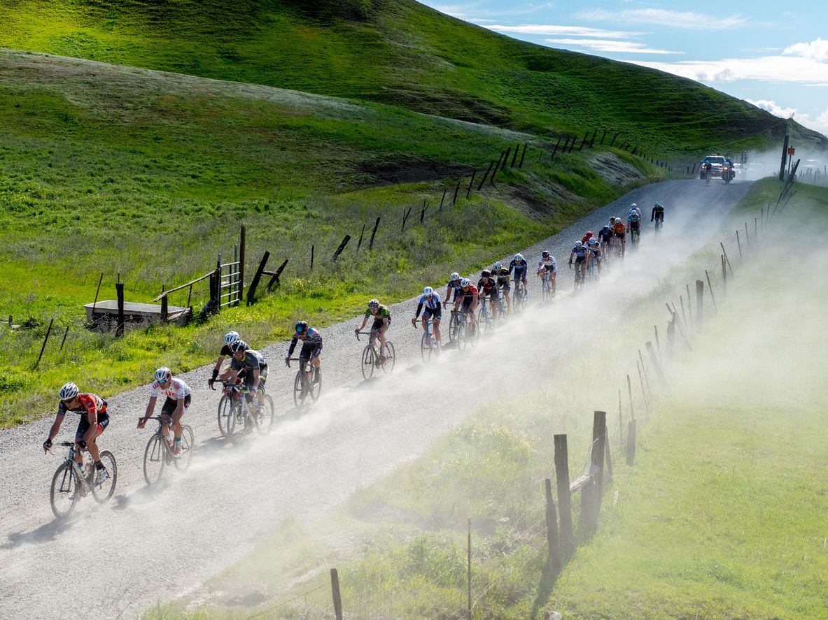 Masters cyclists racing on a rural gravel road