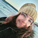 Roxanne Marcelle-Shaw, A woman in a black vest and white shirt standing confidently.