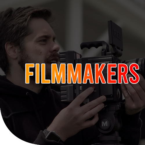 A male holding a filming camera