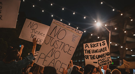 A group of protestants carrying statement boards about justice