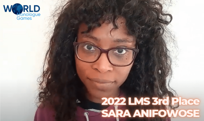 Sara Anifowose - A curly haired woman wearing a glasses and a red shirt in a white background