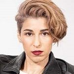 Talin Agon - A woman with short hair wearing a leather jacket, exuding confidence and style.