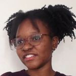 Cris Bocchi, A woman in a black dress with makeup on her face, exuding elegance and confidence.