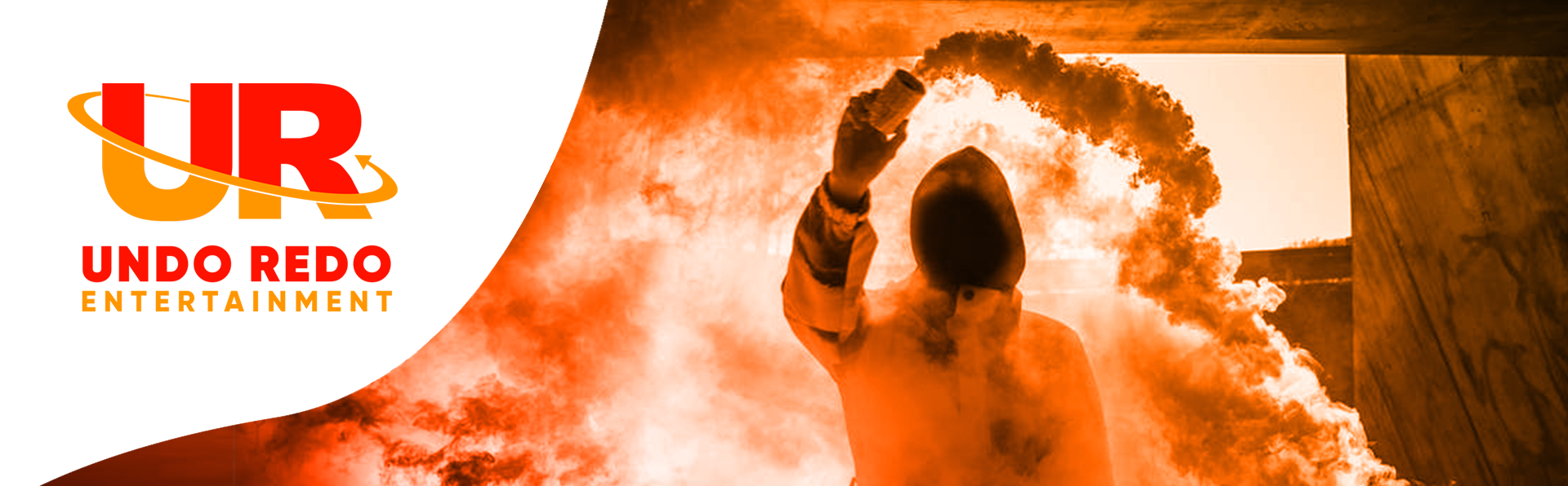 A person spraying a vibrant orange and red smoke gas