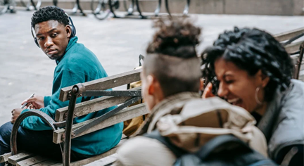 A group of people laughing at a guy 