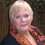 Roxanne Marcelle-Shaw, A woman in a black vest and white shirt standing confidently.