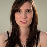 Angharad Thompson Rees - a dark brown haired woman in a black spaghetti strap shirt