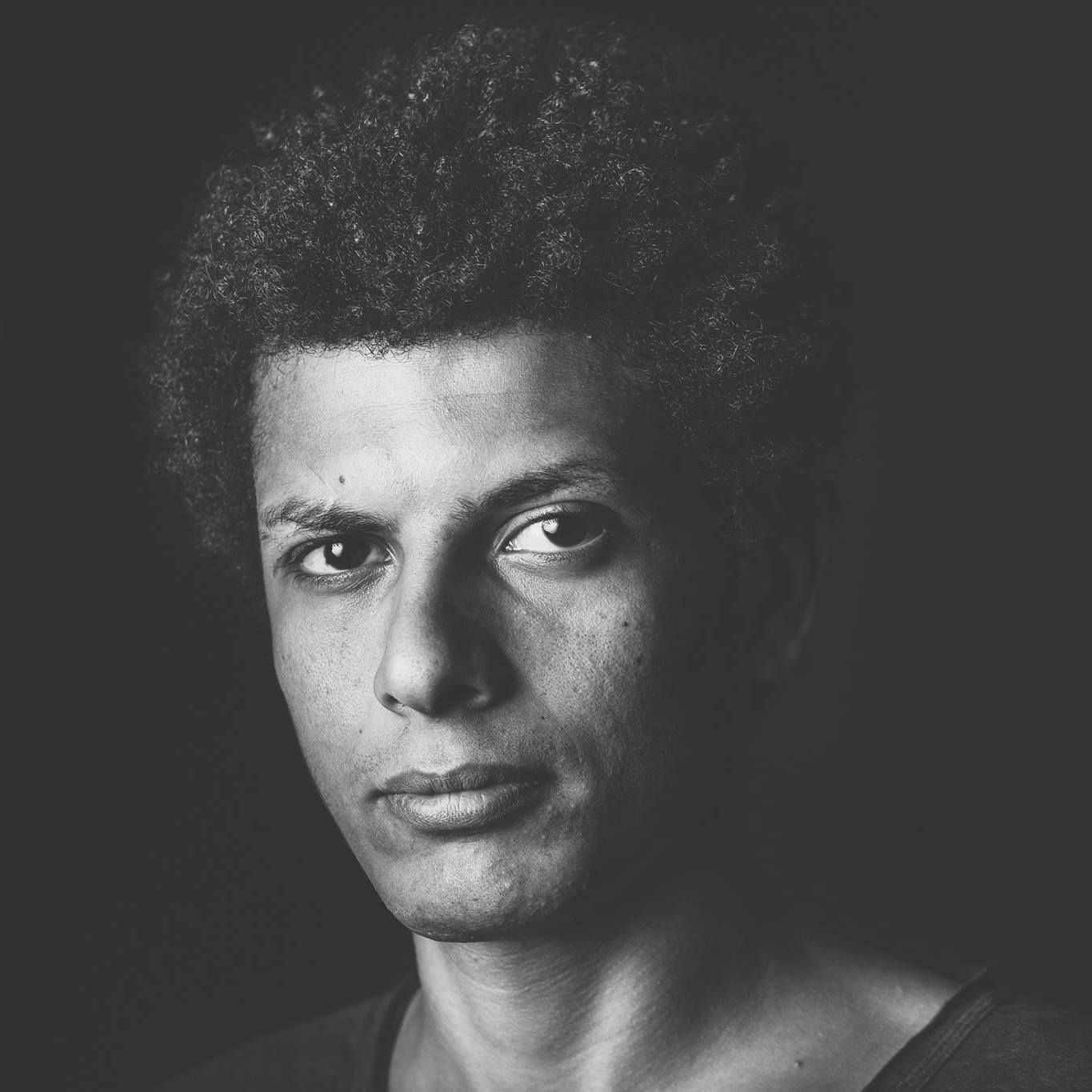 Ahmed Samy - A black and white image of a curly haired guy
