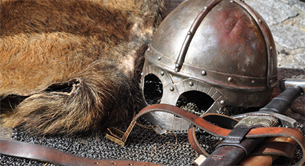 A battle costume of a soldier including a helm and a dagger