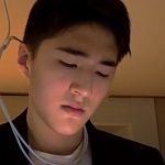 Jay Choi, A professional asian man in a suit working on a laptop computer.