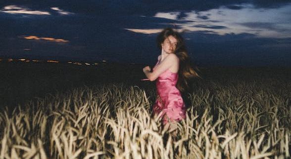 A girl that is lost in the cornfield at night