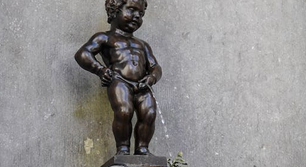 A statue of a peeing child