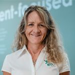 Cris Bocchi, A woman in a black dress with makeup on her face, exuding elegance and confidence.