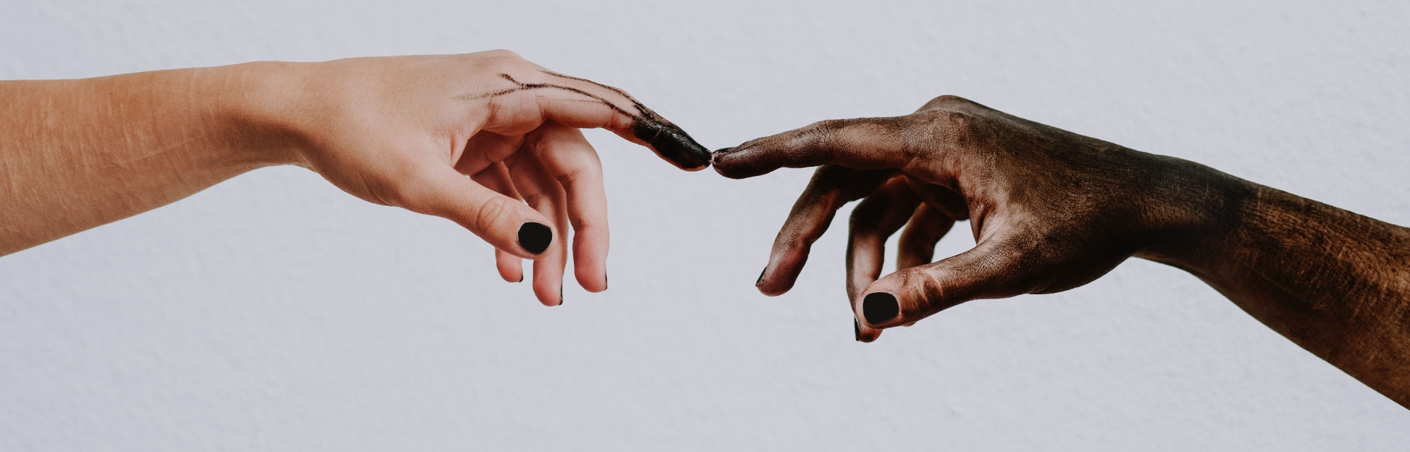 Two hands from different nationality that are aligned