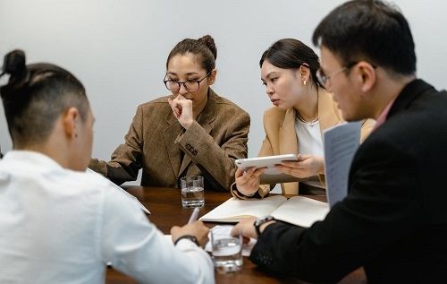 Four people in a meeting discussing a topic