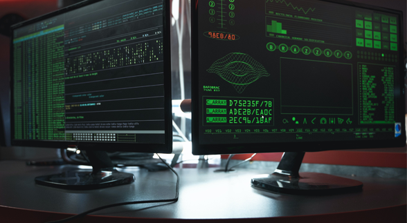 Two desktop computer showing different codes that looks like a virus