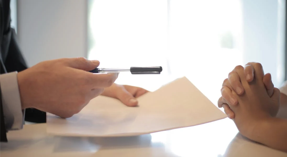 A dealer talking to a client waiting to sign a contract