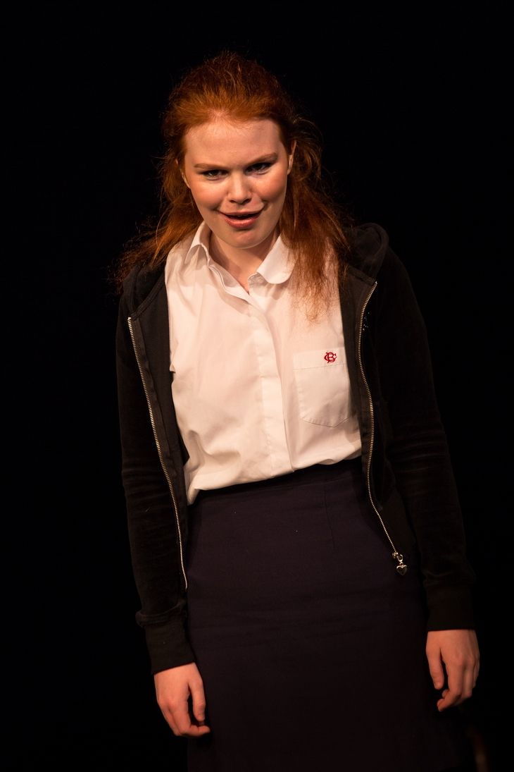 Laughing and Folded arms Blonde girl wearing a white polo, black jacket and navy blue skirt
