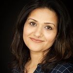 Bindoo, A black haired woman smiling in the camera