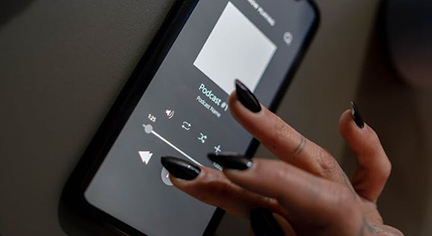 Woman hand on the phone playing a music in an app