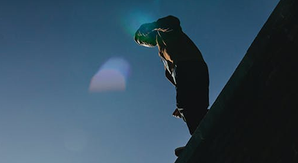 A man in an edge of a bridge preparing top jump
