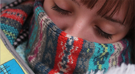 A sleeping woman covered with a scarf