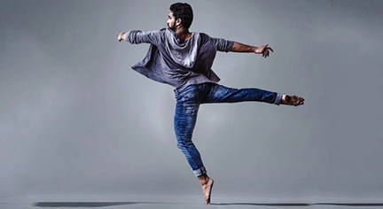 A ballerina guy dancing in an open space