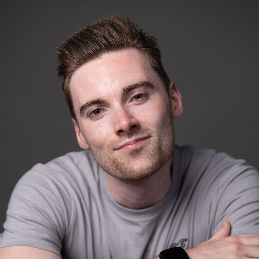 Tim Charles, A white guy wearing a grey shirt and a watch in a folding arms position