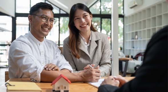 A couple signing up a contract for their dream home