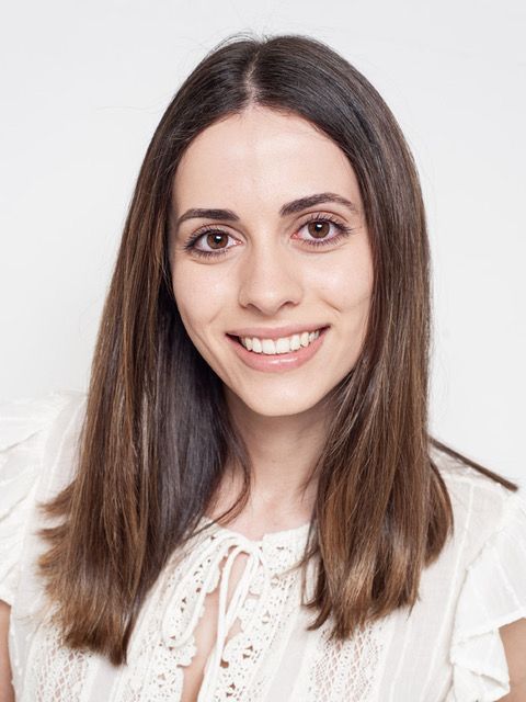 Melissa Abdullah - A brown haired woman wearing white blouse smiling infront of camera