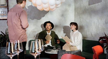 A couple and a server taking their orders