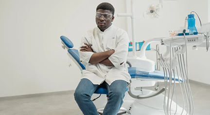 A Dentist looking problematic while sitting on his Dental Chair