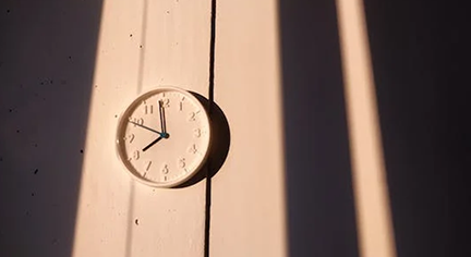 A white clock in a wall