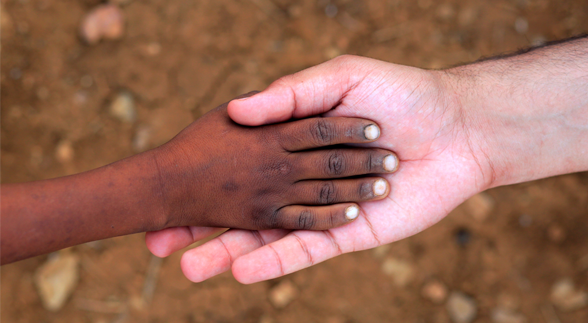 A female's hand on her knees and another man is holding her right hand