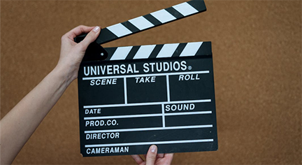Image of a hand holding a clapboard