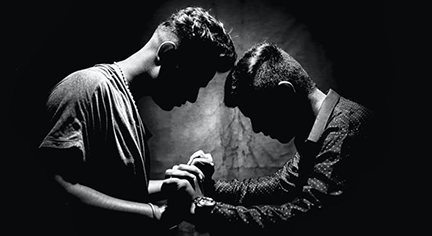 Two guys pushing each other with might