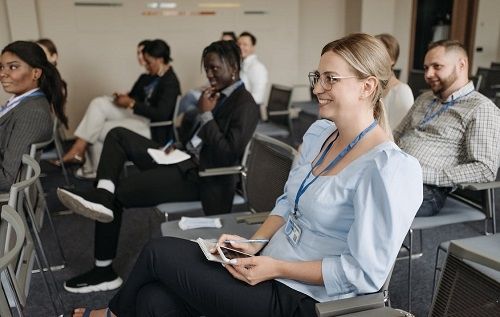 A group of people inside a classroom listening to a lecture