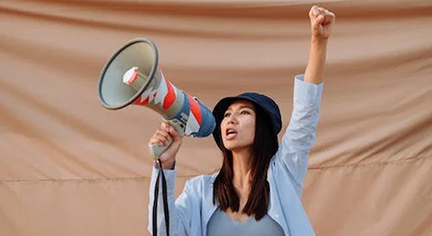 A woman shouting at a megaphone