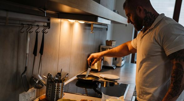 Man holding a flowers behind suprising a girl in front of him