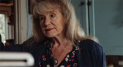 A middle aged woman talking to airport officers