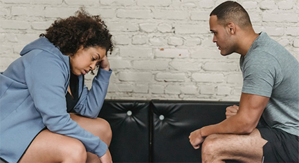 Two couples sitting on a couch talking about their problems