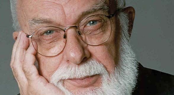 James Randi with white beard and wearing glasses