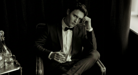 A male wearing a blue coat that has an expression of being "shocked"