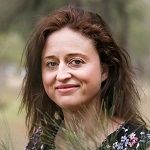 Alison Leader, A woman standing in a forest with a tree in the background