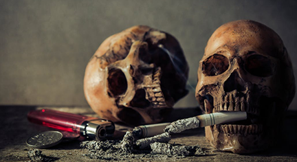 Two skulls biting a cigarette with ashes, lighter and a coin beside it