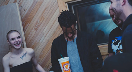 A man being bullied by three persons in a party