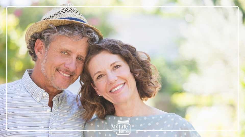 Happy mid-life couple close up, man wearing a hat both smiling