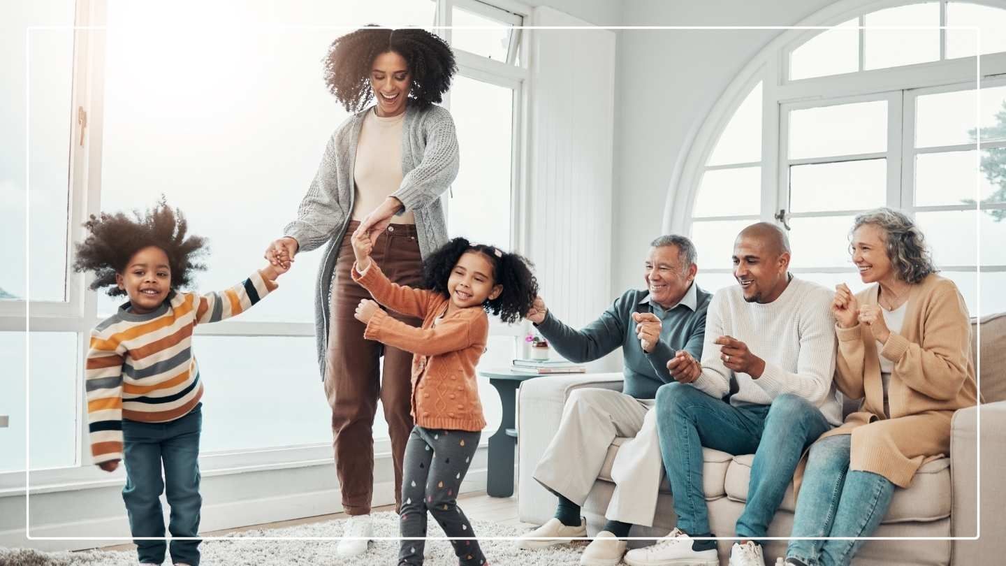 Family life - mother and 2 children dancing with father and grandparents watching