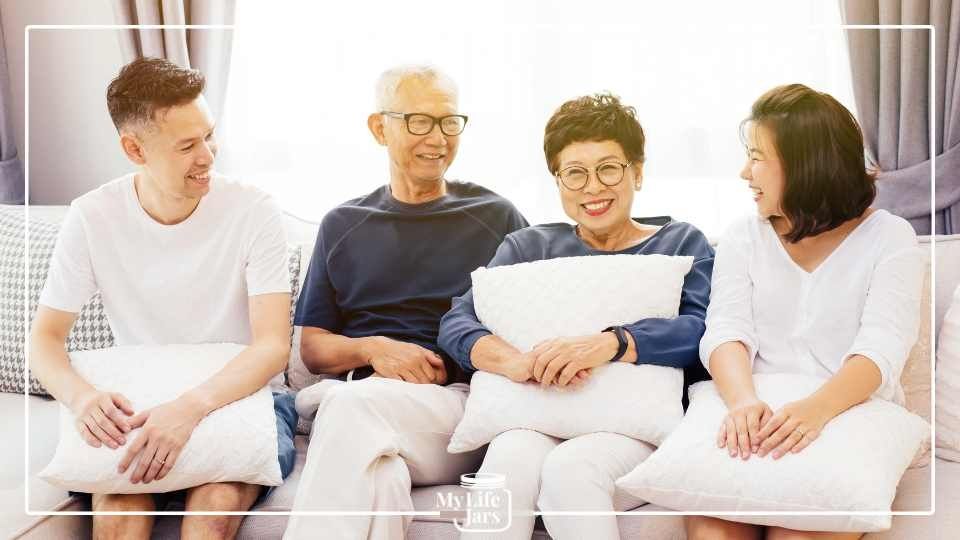 Asian family sitting on couch Mother Father Son Daughter