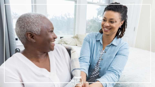 mother and daughter with dark skin in bedroom 
